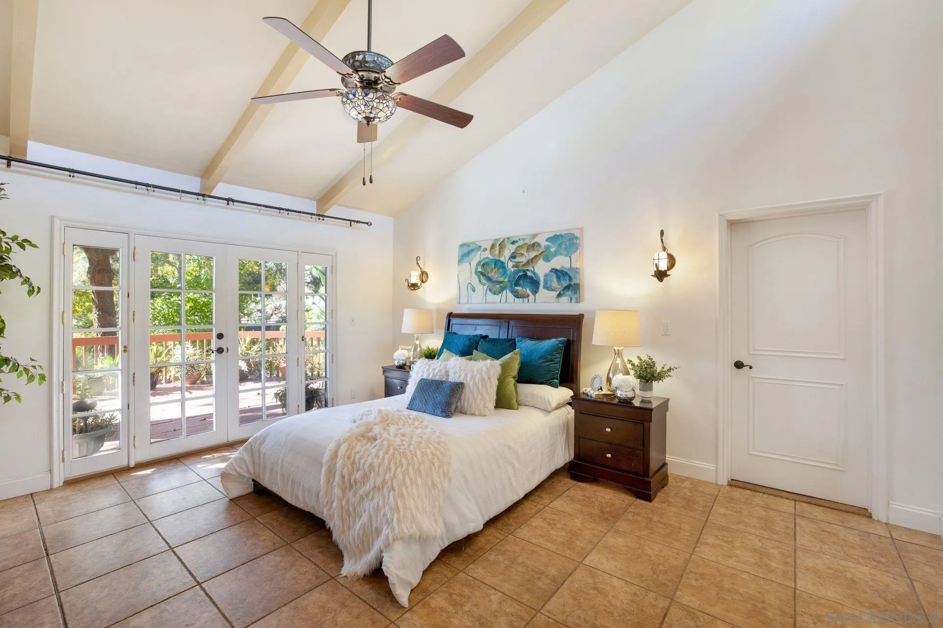 7671 La Brisa Rancho Santa Fe, CA 92067 - Photo 12 of 34 a bedroom with a bed and a chandelier