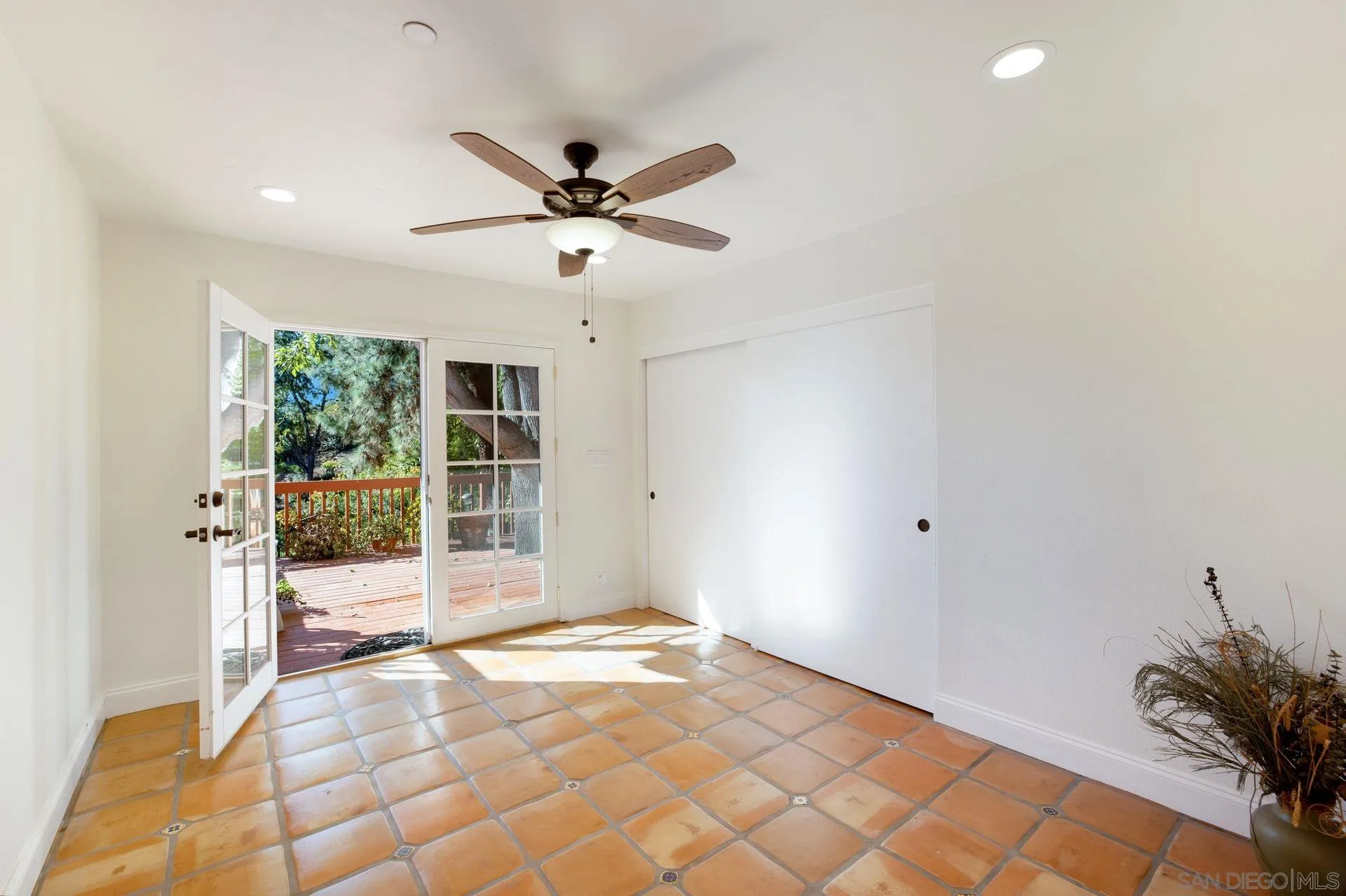 7671 La Brisa Rancho Santa Fe, CA 92067 - Photo 16 of 34 a view of a livingroom with a ceiling fan and window