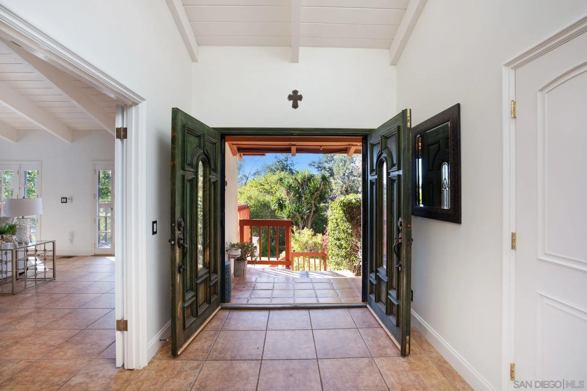 7671 La Brisa Rancho Santa Fe, CA 92067 - Photo 2 of 34 a hallway with wooden floor chandelier and glass door