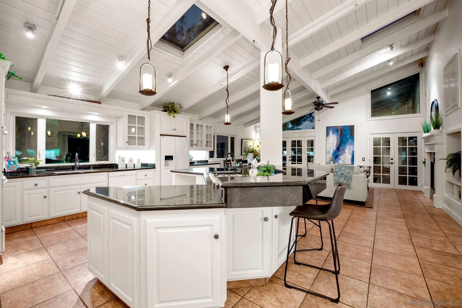 7671 La Brisa Rancho Santa Fe, CA 92067 - Photo 23 of 34 a kitchen with stainless steel appliances kitchen island granite countertop a sink cabinets and living room view
