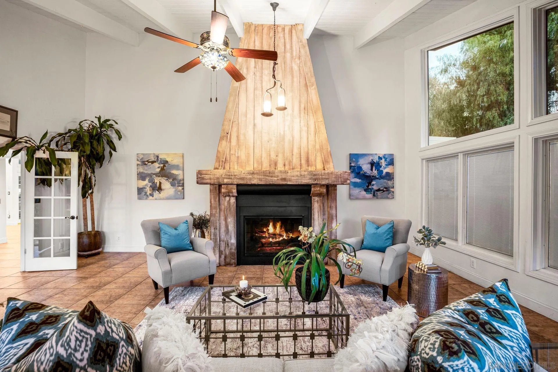7671 La Brisa Rancho Santa Fe, CA 92067 - Photo 4 of 34 a living room with furniture fireplace and a large window