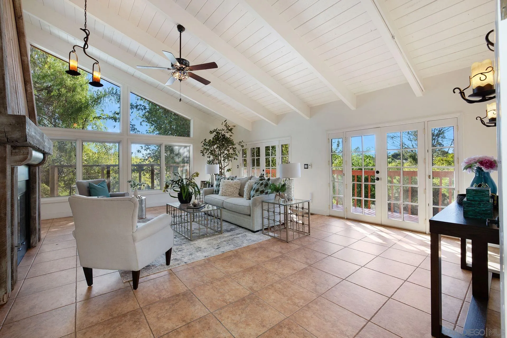 7671 La Brisa Rancho Santa Fe, CA 92067 - Photo 5 of 34 a living room with patio furniture and a floor to ceiling window