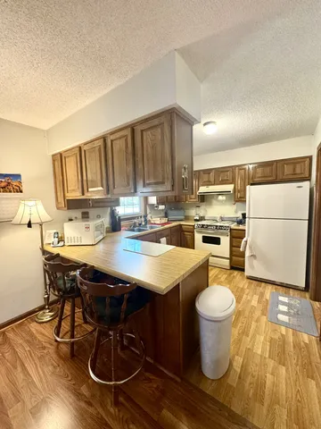 a kitchen with a table chairs and a refrigerator