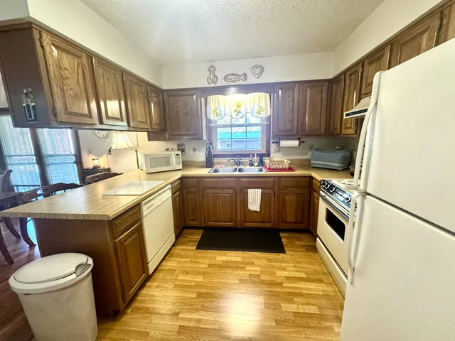 a kitchen with a sink a stove a refrigerator and cabinets