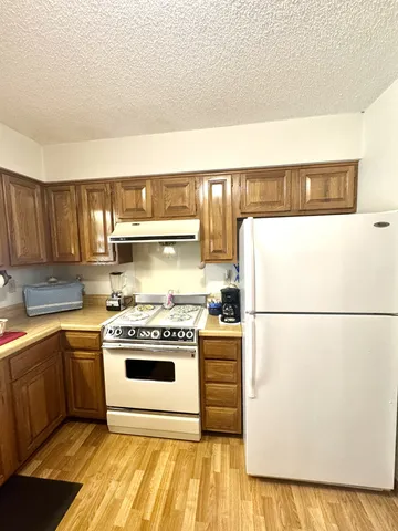 a white stove top oven sitting inside of a kitchen