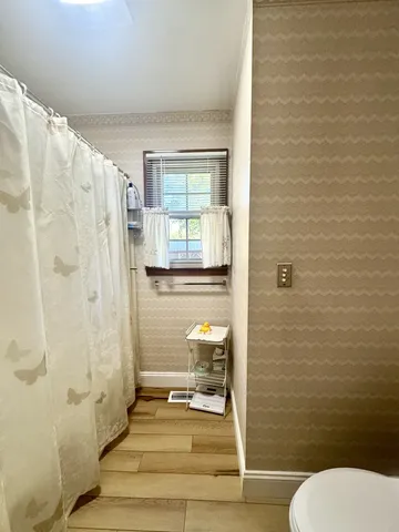 a bathroom with a toilet and a shower