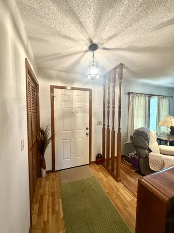 a bedroom with furniture and a chandelier
