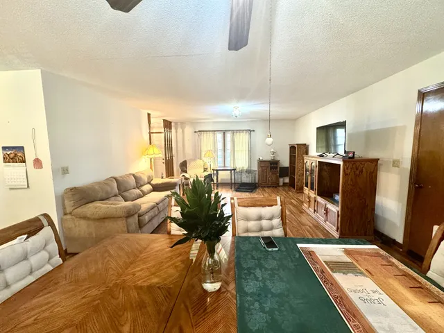 a living room with furniture fireplace and a large window
