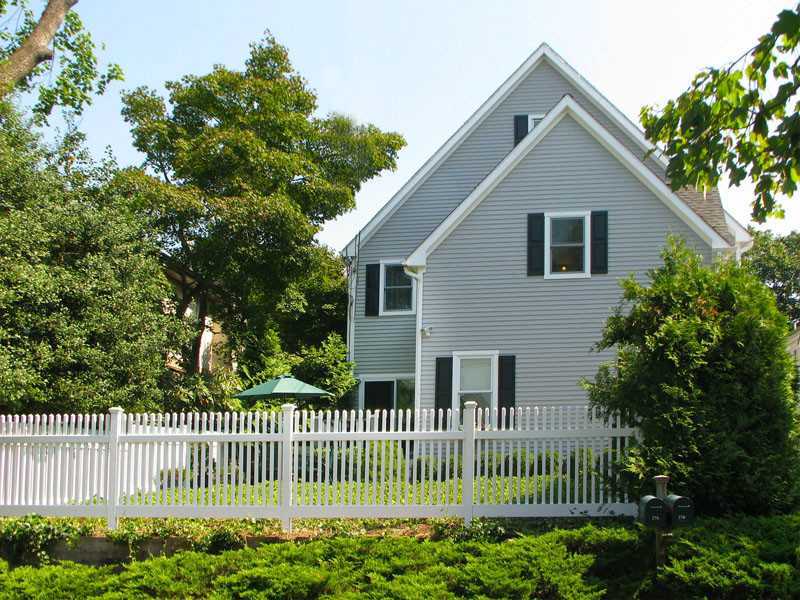 27 Home Place, Unit A Greenwich, CT 06830 - Photo 1 of 17 a front view of a house with a garden