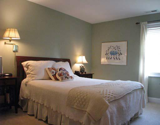 27 Home Place, Unit A Greenwich, CT 06830 - Photo 13 of 17 a bedroom with a bed and painting on the wall