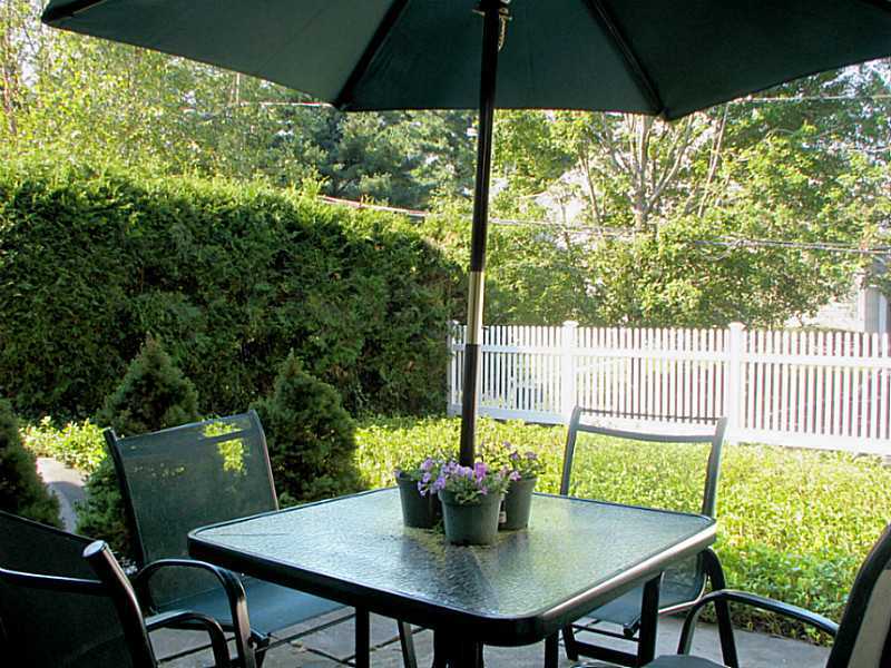 27 Home Place, Unit A Greenwich, CT 06830 - Photo 15 of 17 a view of an outdoor space with furniture and umbrella