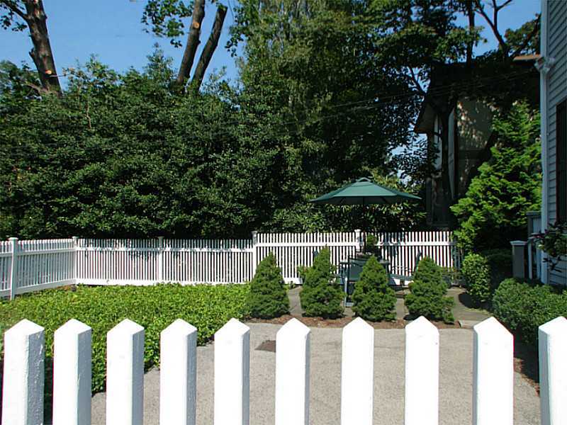 27 Home Place, Unit A Greenwich, CT 06830 - Photo 16 of 17 a front view of house with yard and green space