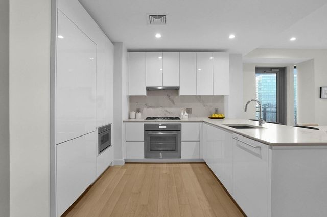 a kitchen with a refrigerator and a sink