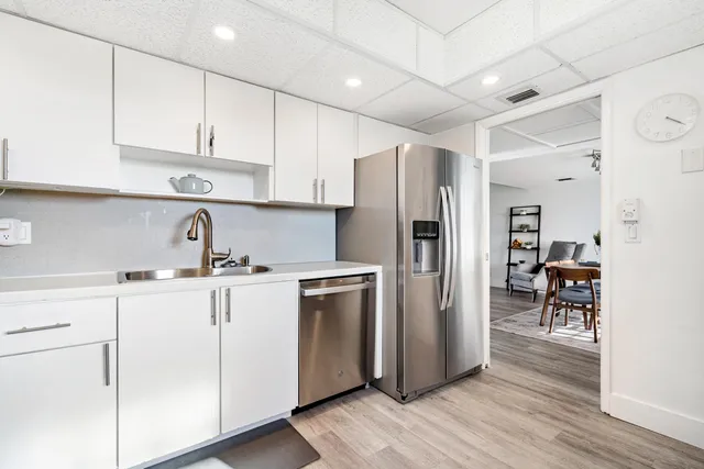 a kitchen with stainless steel appliances kitchen island granite countertop a stove and a microwave
