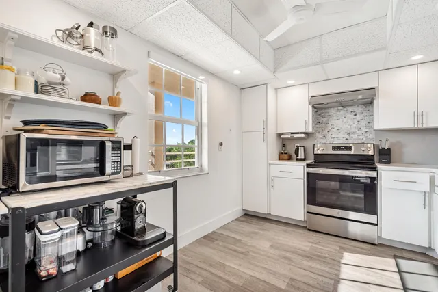 a kitchen with stainless steel appliances a refrigerator and a stove