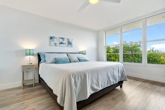 a bedroom with a large bed and a chandelier