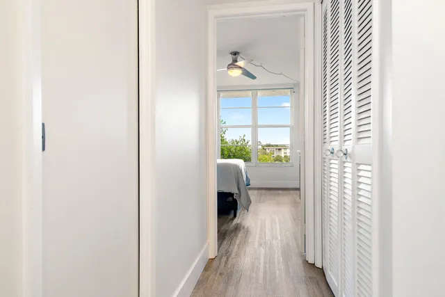 a bathroom with a double vanity sink and mirror with window