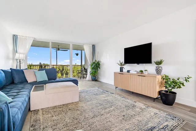 a living room with furniture a rug and a window