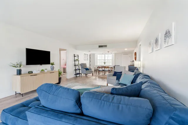 a dining room with furniture and wooden floor