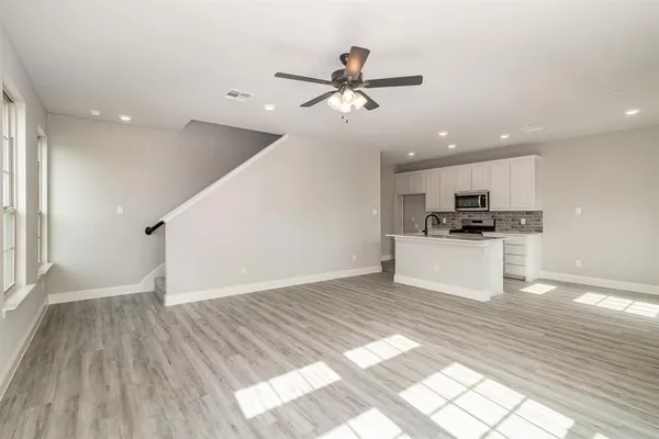 a view of kitchen with sink microwave and refrigerator