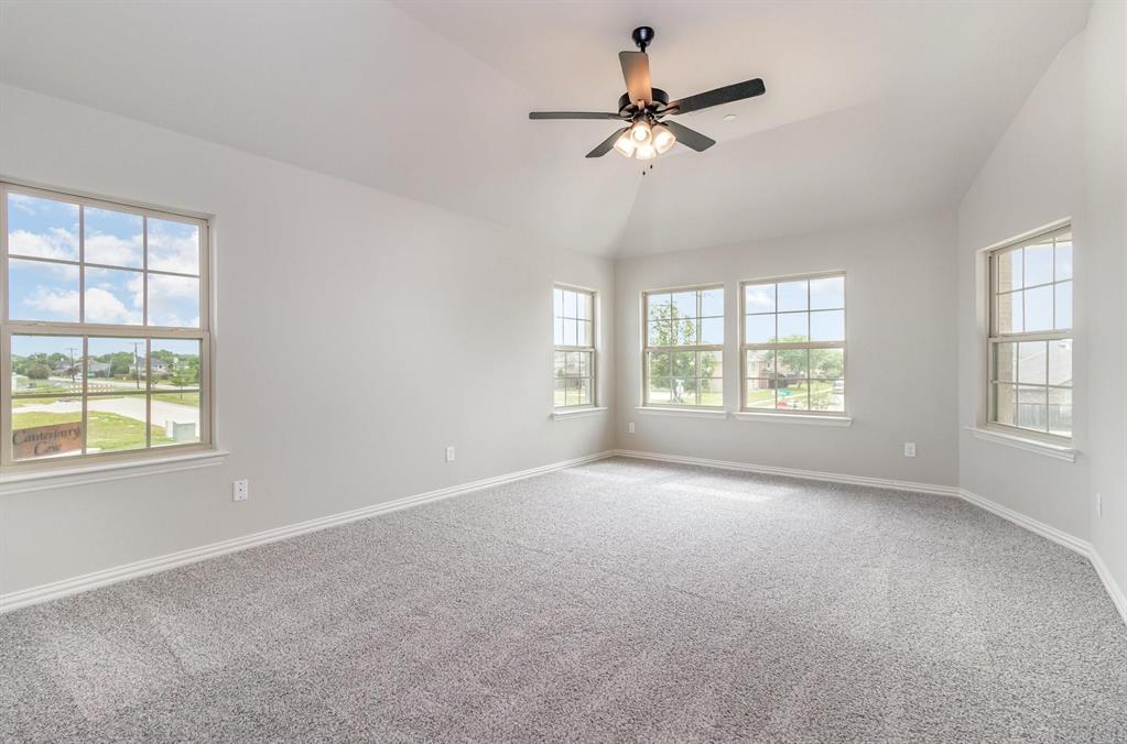3621 Geoffrey Trail Rowlett, TX 75088 - Photo 8 of 12 an empty room with windows and fan chandelier