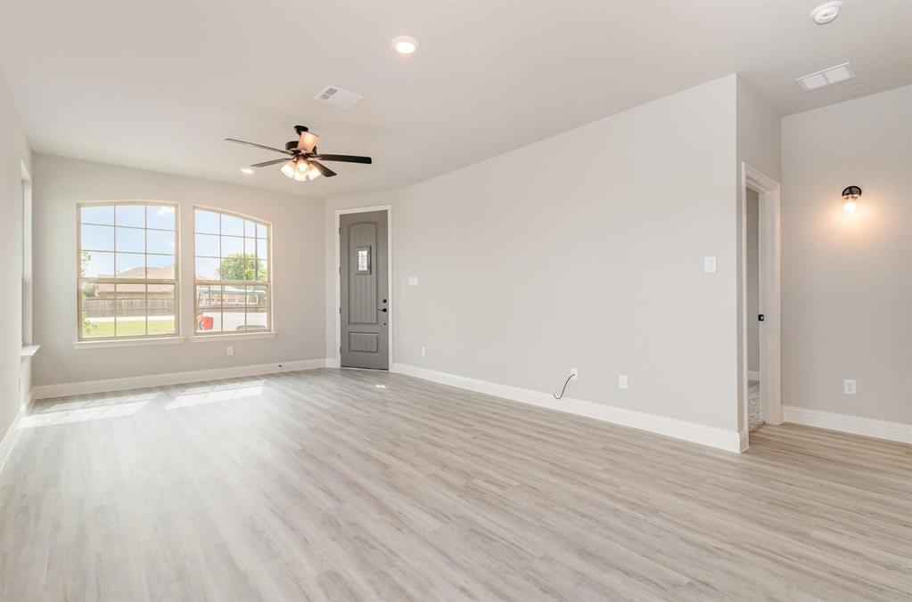 3621 Geoffrey Trail Rowlett, TX 75088 - Photo 9 of 12 a view of an empty room with window and wooden floor