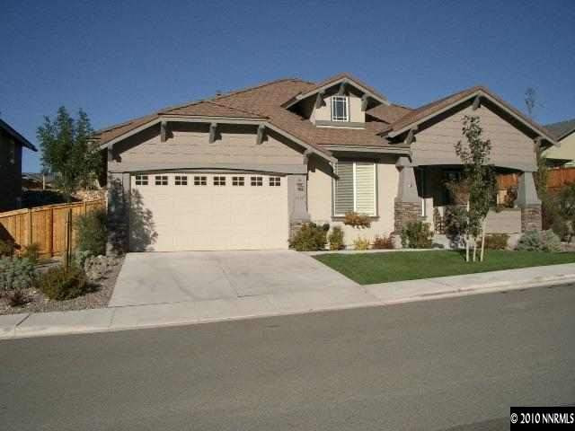 4890 Turning Leaf Way Reno, NV 89519 - Photo 1 of 9 a front view of a house with a yard and garage