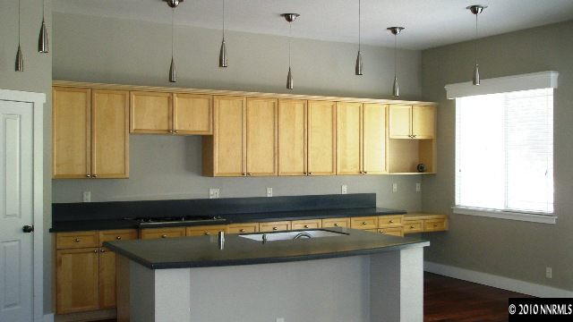 4890 Turning Leaf Way Reno, NV 89519 - Photo 2 of 9 a kitchen with a sink a window and cabinets