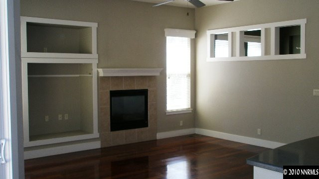 4890 Turning Leaf Way Reno, NV 89519 - Photo 3 of 9 a view of an empty room with wooden floor and a window