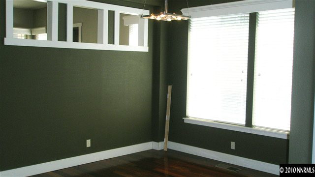 4890 Turning Leaf Way Reno, NV 89519 - Photo 5 of 9 a view of an empty room with wooden floor and a window
