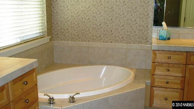4890 Turning Leaf Way Reno, NV 89519 - Photo 7 of 9 a bathroom with a tub and a sink