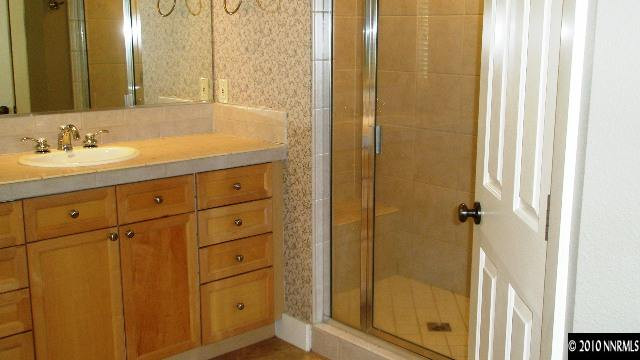 4890 Turning Leaf Way Reno, NV 89519 - Photo 8 of 9 a bathroom with a shower sink and mirror