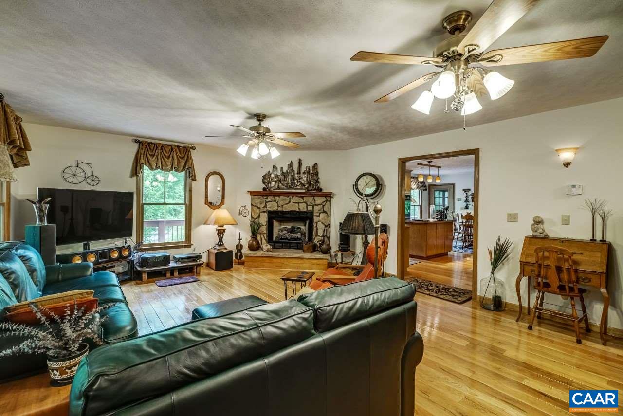 1531 Riding Club Road Keene, VA 22946 - Photo 8 of 27 A handsome fireplace can be the center piece of this large (22x17) room. So can the many windows looking out into the woods and the landscaping.