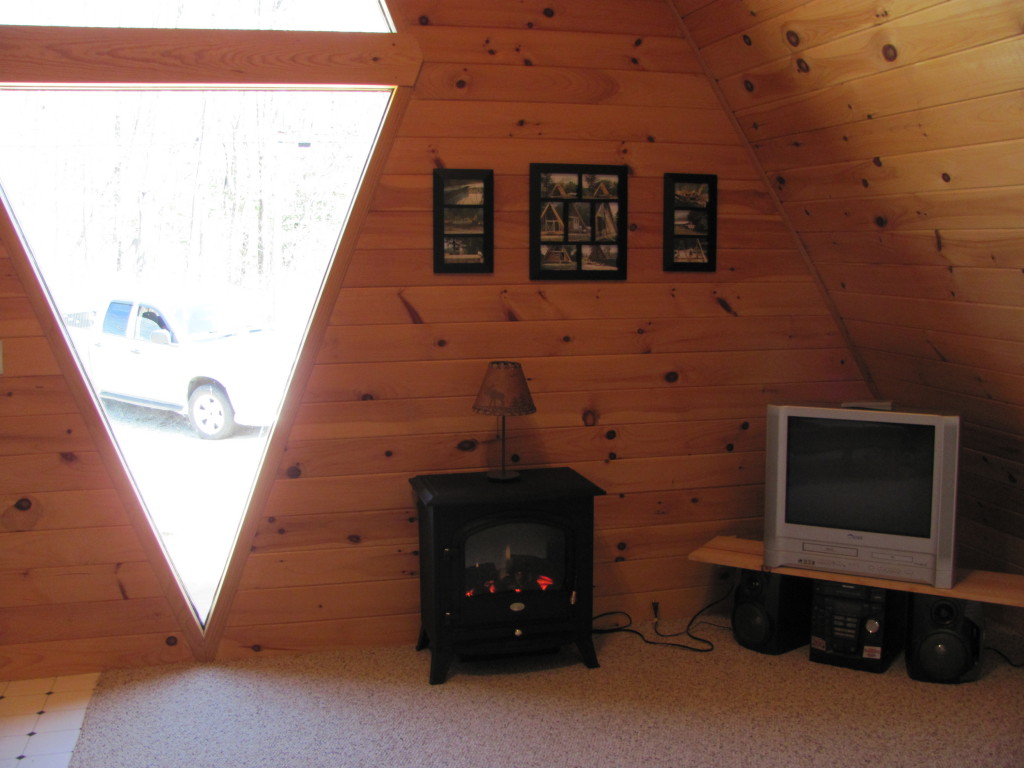 1525 North Main Road Otis, MA 01253 - Photo 2 of 13 a living room with furniture and a fireplace