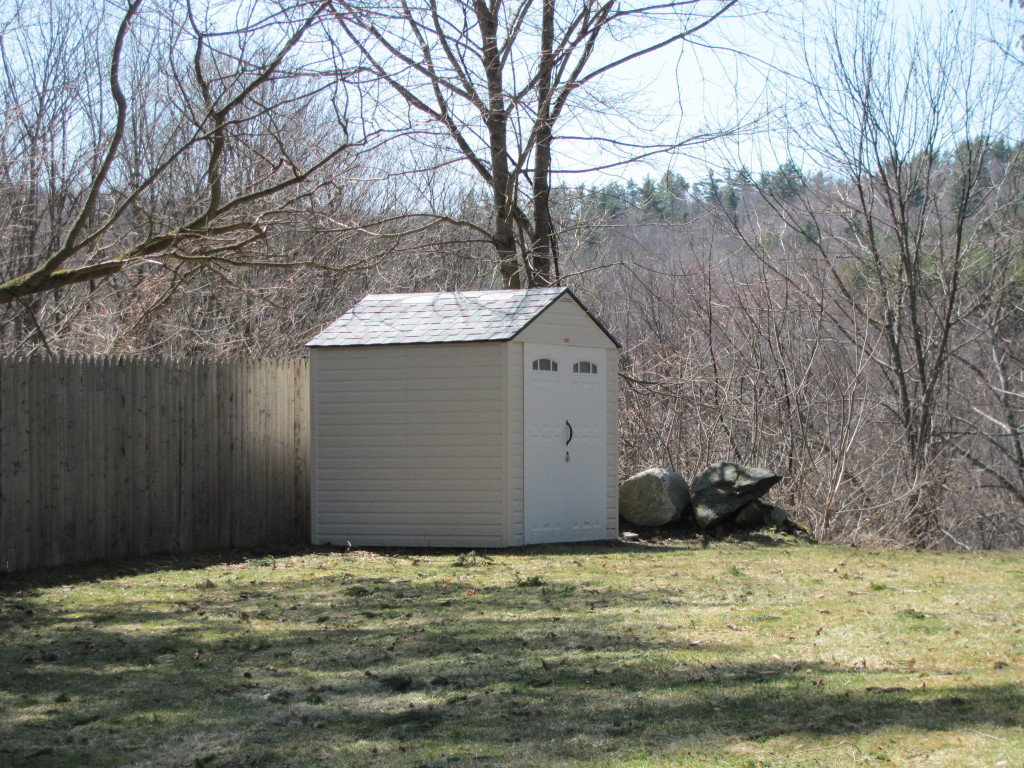 1525 North Main Road Otis, MA 01253 - Photo 8 of 13 a backyard of a house with large trees and wooden fence