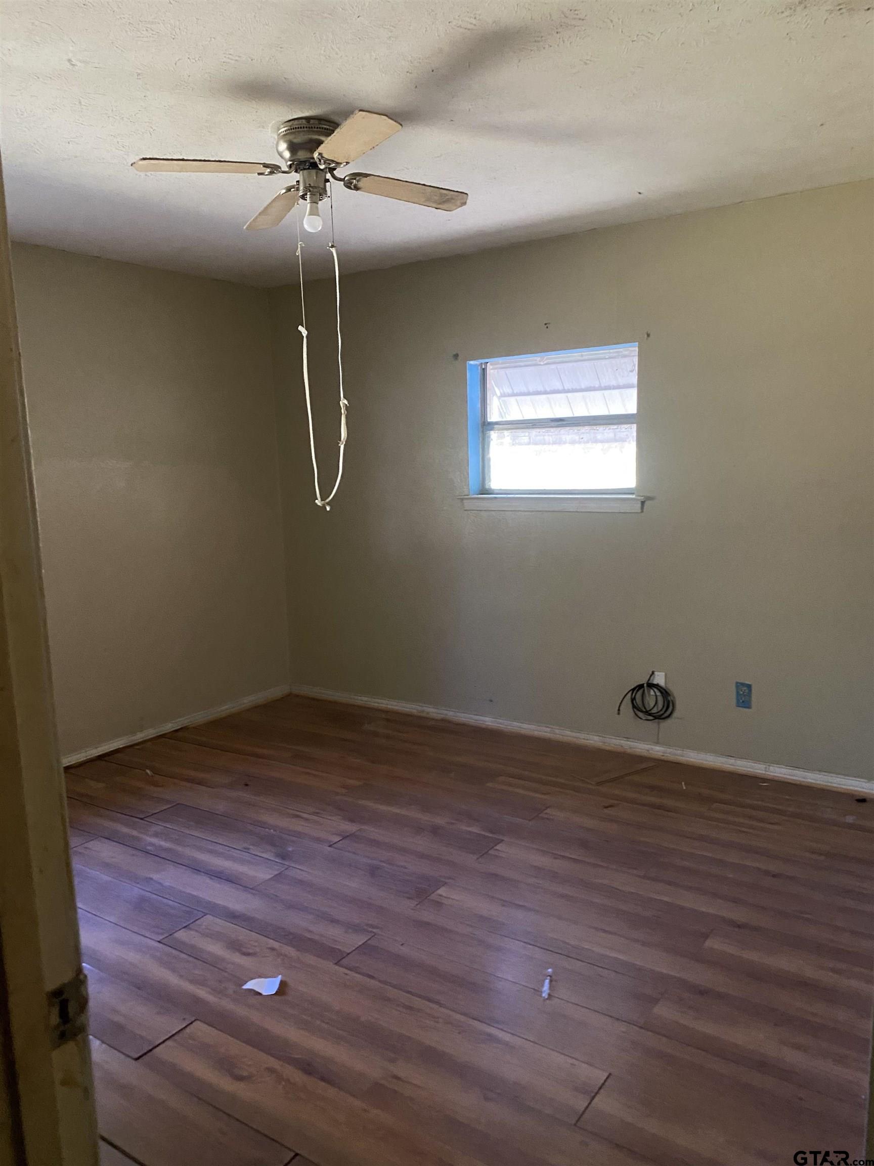 3549 Fm 69 Quitman, TX 75783 - Photo 9 of 32 a view of a room with wooden floor and fan