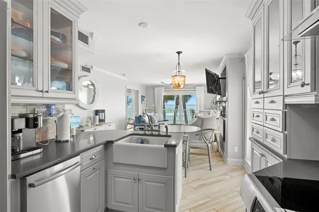 a kitchen with cabinets and wooden floor