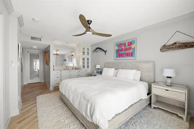 a spacious bedroom with a bed and a chandelier