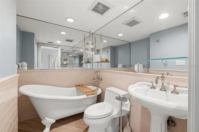 a bathroom with a sink a toilet and a mirror