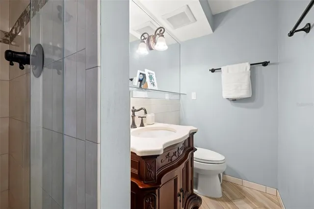 a bathroom with a sink toilet and a mirror