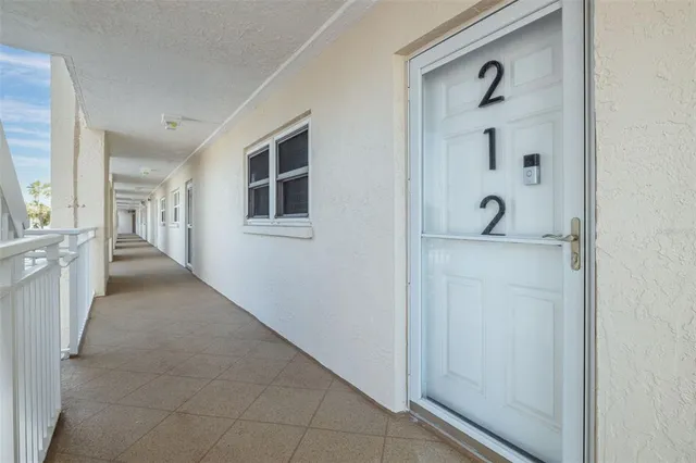 a view of a hallway with closet and wooden floor