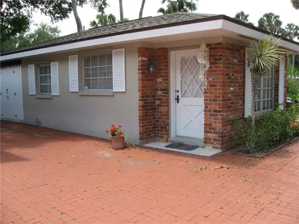 a view of a house with backyard and garage