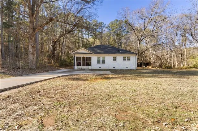 a house view with swimming pool in front of it