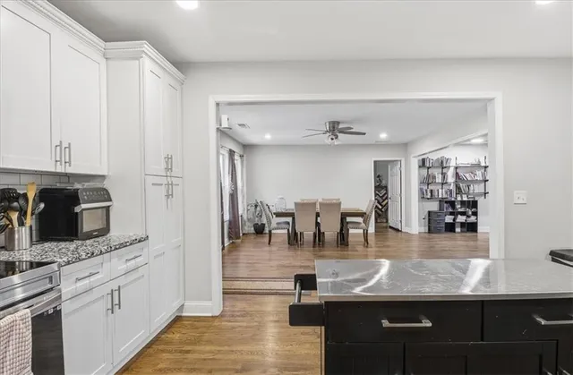 a kitchen with stainless steel appliances granite countertop a sink counter space and cabinets