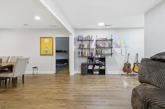 a living room with furniture and wooden floor