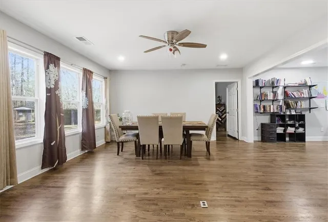 a view of a dining room with furniture and wooden floor