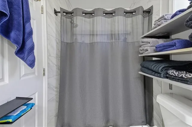 a bathroom with a shower curtain and a sink