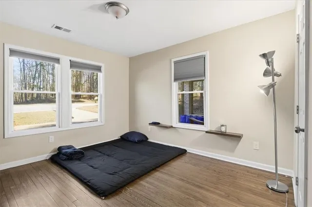 a living room with a bed furniture and a window