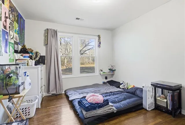 a bedroom with furniture and a window
