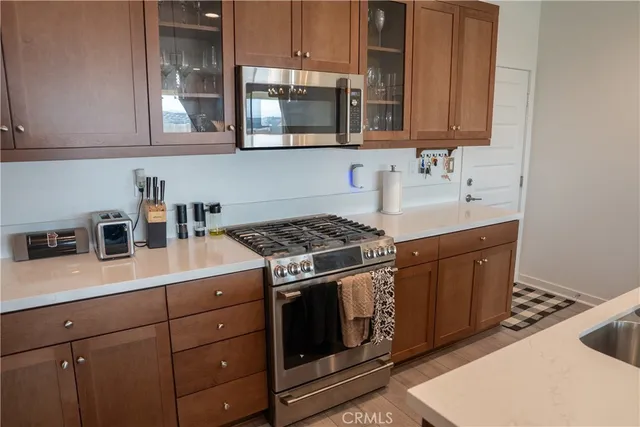a kitchen with stainless steel appliances granite countertop a sink stove and microwave